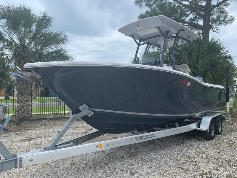 Slide: The Image of 2018 Sea Fox 248 Commander boat on trailer, parked outdoors with palm trees in background. - 3