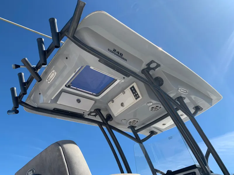 Slide: The Image of 2018 Sea Fox 248 Commander boat roof with rod holders under clear blue sky. - 8