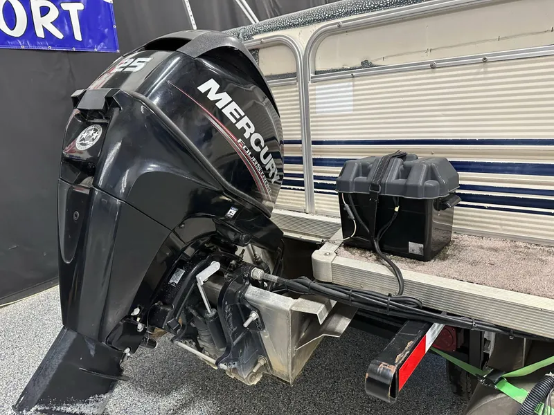 Slide: The Image of 1998 Sylvan Elite 20 boat with Mercury 125 outboard motor and battery box. - 19