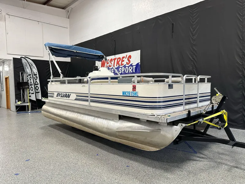 Slide: The Image of 1998 Sylvan Elite 20 pontoon boat displayed at Westre's Marine & Sport showroom. - 2