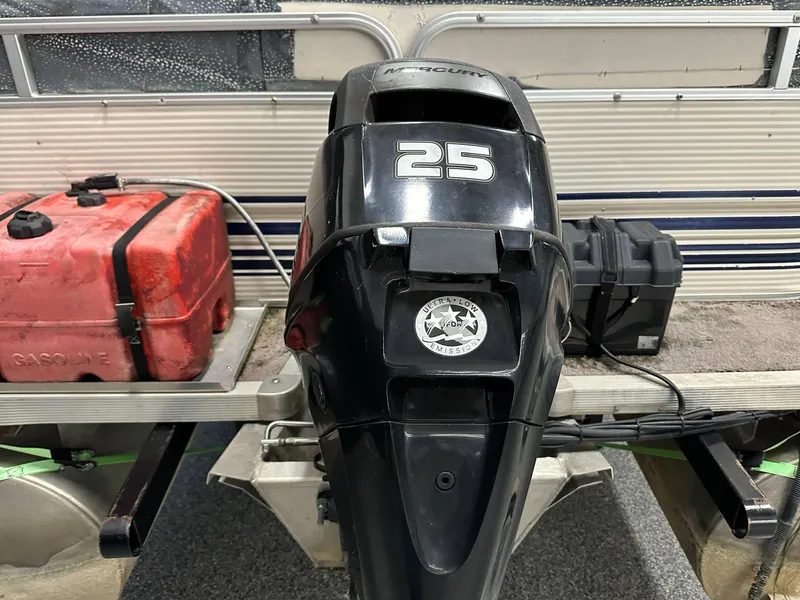 Slide: The Image of Outboard motor on 1998 Sylvan Elite 20 boat with red fuel tank and battery. - 20