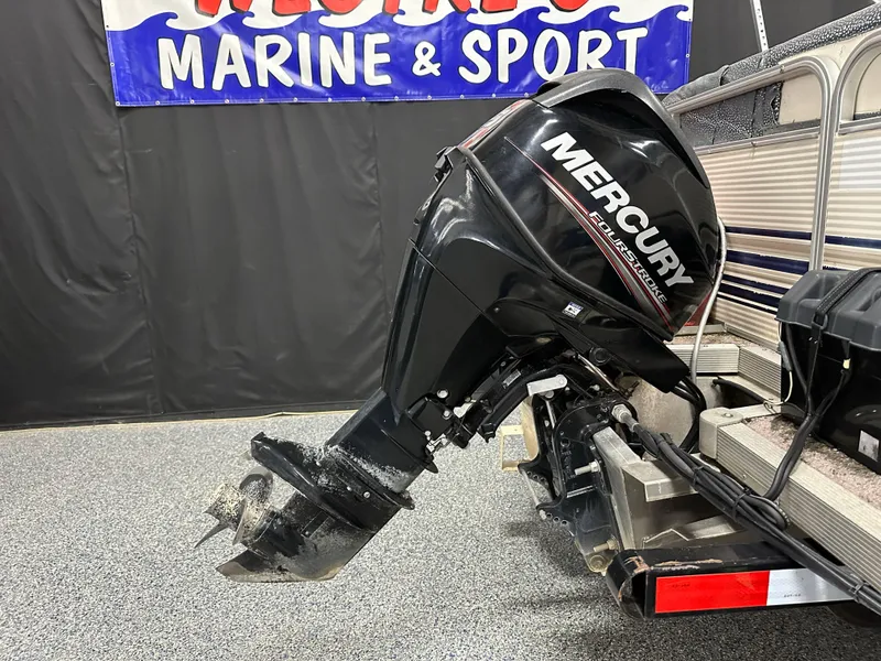 Slide: The Image of 1998 Sylvan Elite 20 boat with Mercury FourStroke outboard motor in showroom. - 21