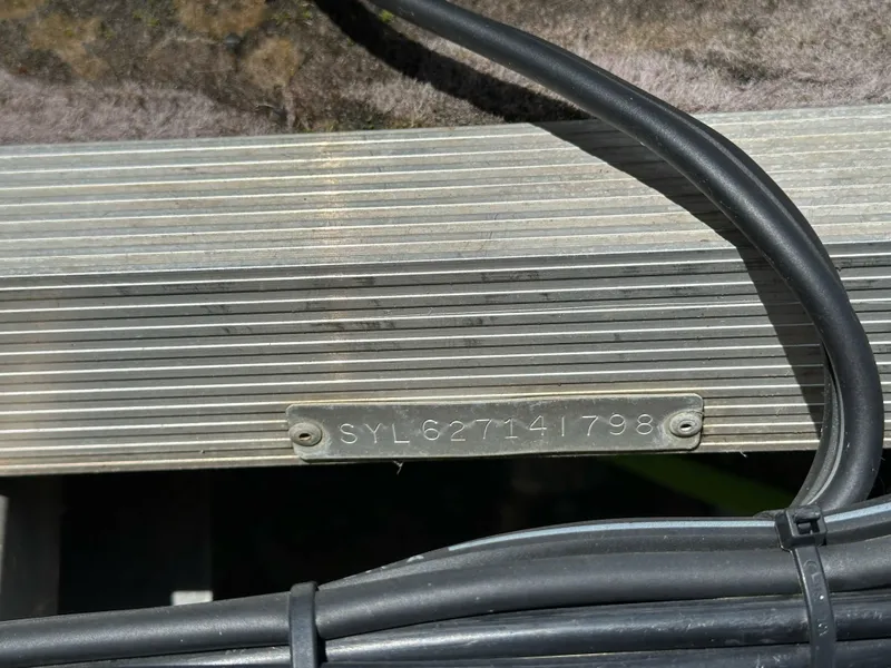Slide: The Image of 1998 Sylvan Elite 20 boat serial number plate with cables. - 22
