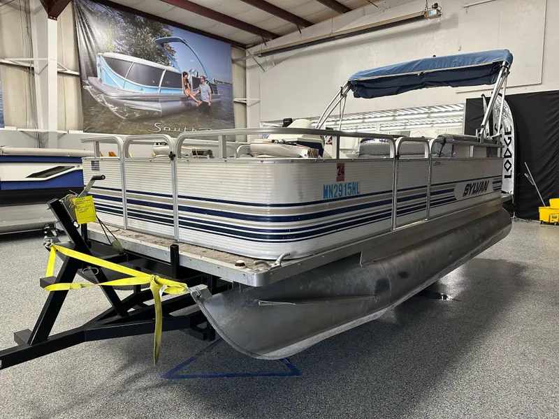 Slide: The Image of 1998 Sylvan Elite 20 pontoon boat on trailer in indoor showroom. - 3