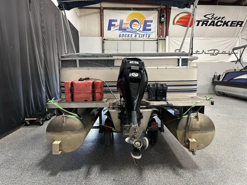 Slide: The Image of 1998 Sylvan Elite 20 pontoon boat with outboard motor in a showroom. - 5