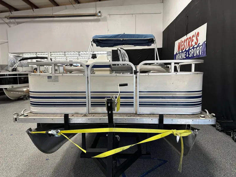 Slide: The Image of 1998 Sylvan Elite 20 pontoon boat in showroom, front view with blue canopy. - 7