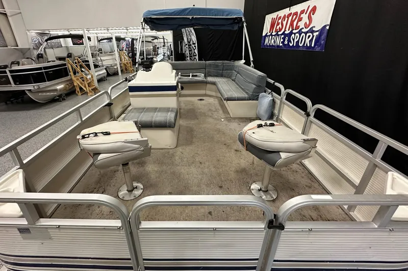 Slide: The Image of 1998 Sylvan Elite 20 pontoon boat interior with seating and steering console. - 8