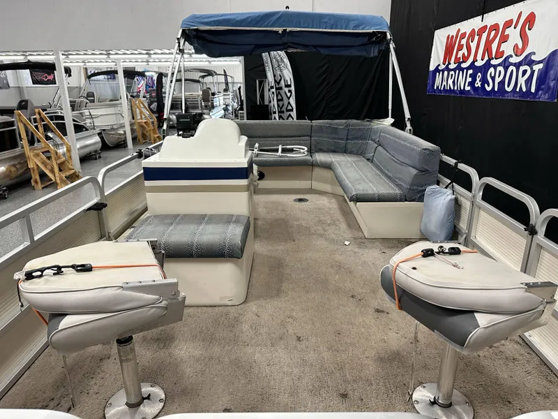Slide: The Image of 1998 Sylvan Elite 20 pontoon boat interior with seating and canopy at Westre's Marine & Sport. - 9