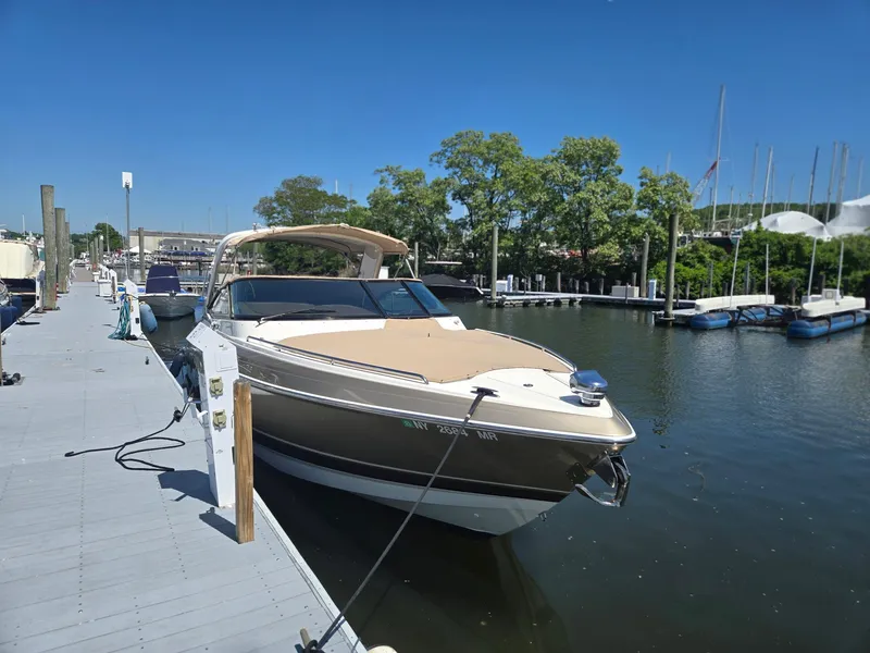 Slide: The Image of 2015 Formula 330 Crossover Bowrider docked at marina under clear blue sky. - 3