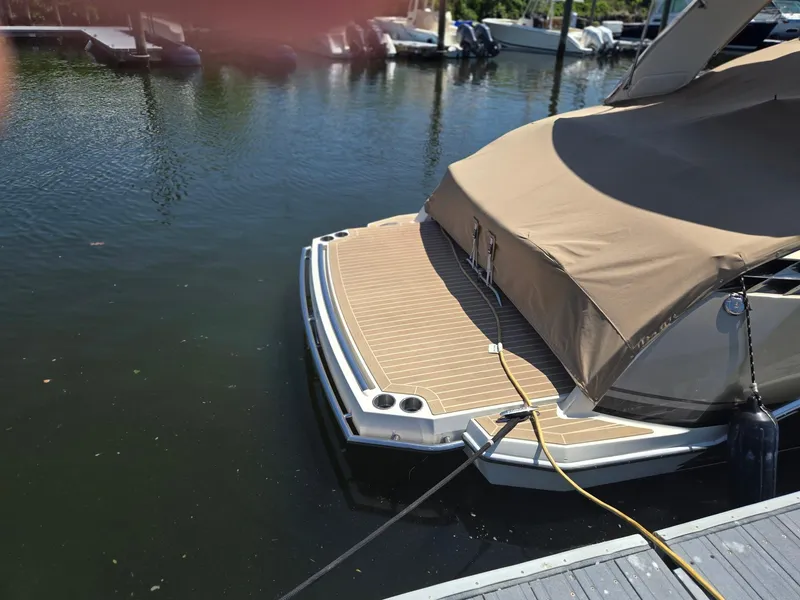 Slide: The Image of 2015 Formula 330 Crossover Bowrider docked with cover, rear view. - 5