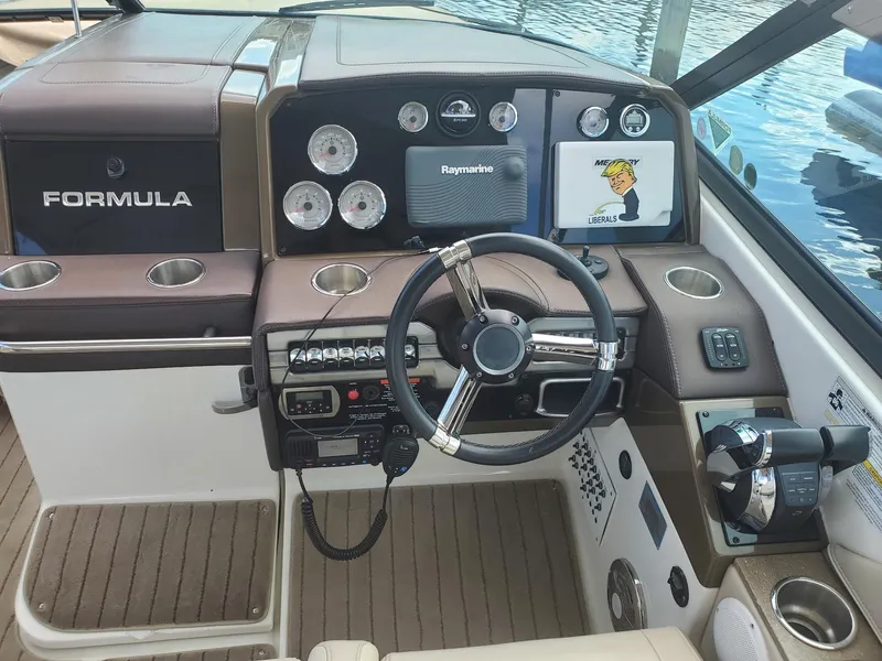 Slide: The Image of 2015 Formula 330 Crossover Bowrider dashboard with steering wheel and navigation controls. - 7