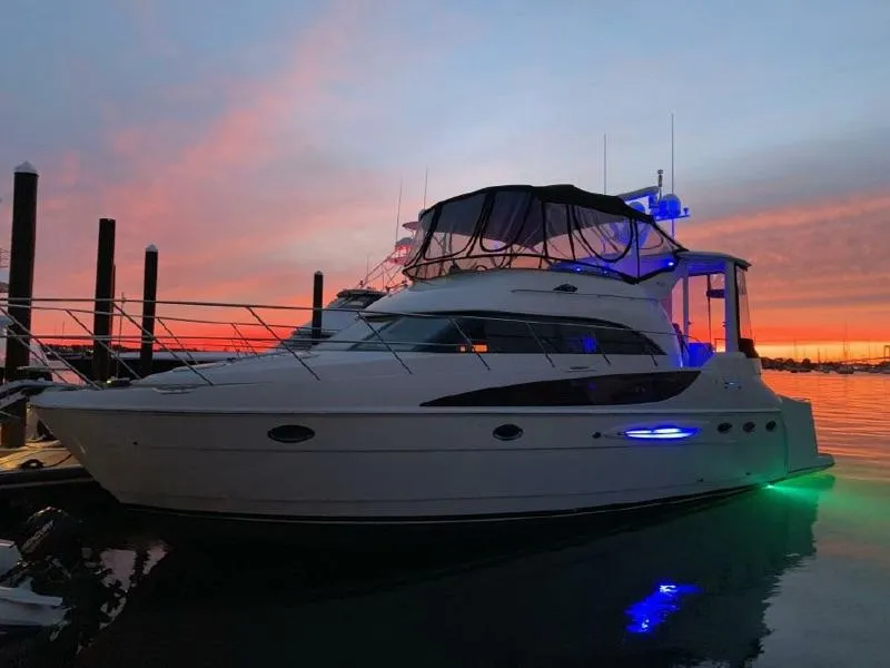 Slide: The Image of 2004 Meridian 459 Motor Yacht docked at sunset with vibrant sky and water reflections. - 11