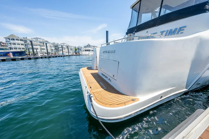 Slide: The Image of 2004 Meridian 459 Motor Yacht docked at marina with waterfront buildings in background. - 18