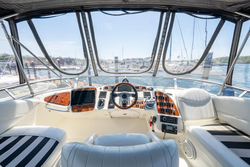 Slide: The Image of 2004 Meridian 459 Motor Yacht helm with luxurious seating and marina view. - 20