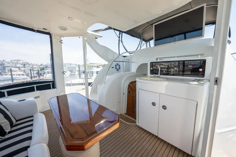 Slide: The Image of Luxurious interior of 2004 Meridian 459 Motor Yacht with wood table and seating. - 24