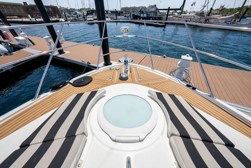 Slide: The Image of 2004 Meridian 459 Motor Yacht bow with striped cushions, docked at a marina. - 28