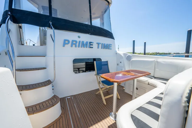 Slide: The Image of 2004 Meridian 459 Motor Yacht deck with seating and table under clear blue sky. - 3