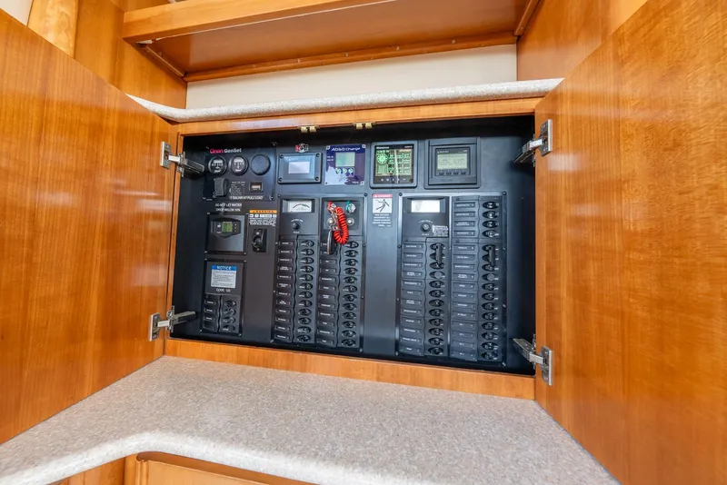 Slide: The Image of Electrical panel inside 2004 Meridian 459 Motor Yacht, featuring various switches and controls. - 32