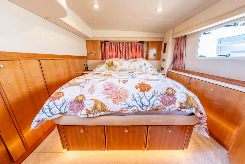 Slide: The Image of Luxurious bedroom interior of 2004 Meridian 459 Motor Yacht with ocean-themed bedding. - 35