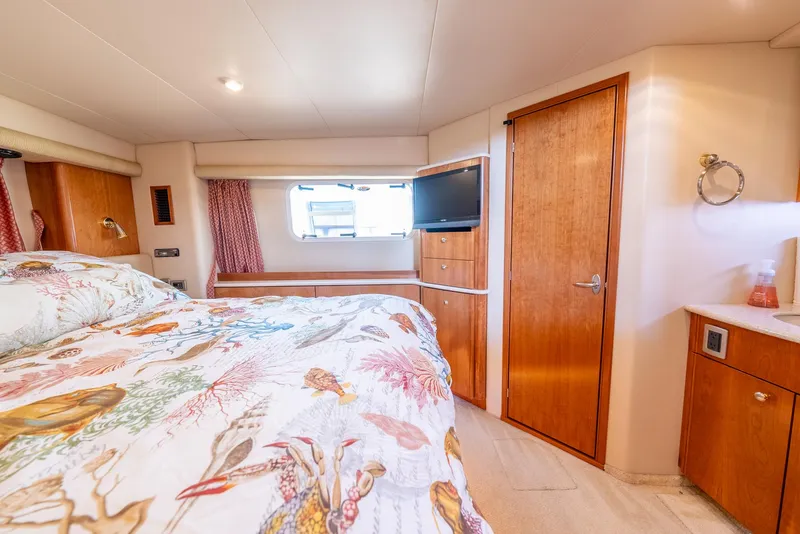 Slide: The Image of Luxurious bedroom interior of 2004 Meridian 459 Motor Yacht with floral bedding and wooden accents. - 36