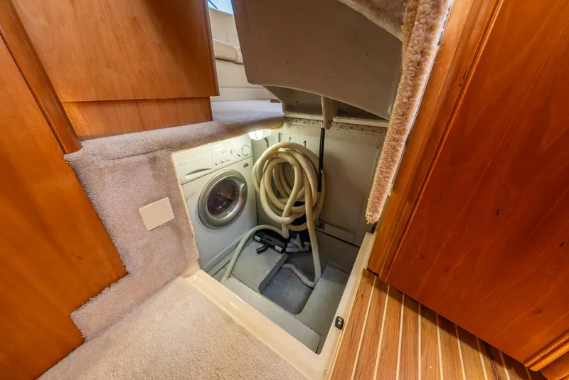 Slide: The Image of Laundry area in 2004 Meridian 459 Motor Yacht with washing machine and hose storage. - 39