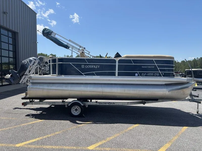 Slide: The Image of 2021 Godfrey SW 2086 C pontoon boat on trailer, parked outdoors. - 12