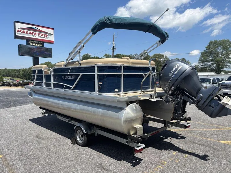 Slide: The Image of 2021 Godfrey SW 2086 C pontoon boat on trailer, parked outdoors under blue sky. - 17
