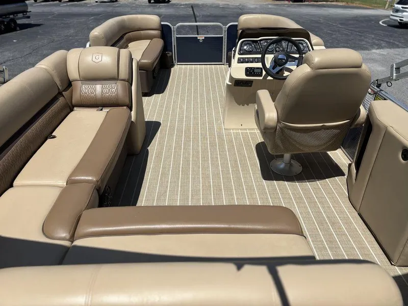 Slide: The Image of Interior of 2021 Godfrey SW 2086 C pontoon boat with beige seating and steering console. - 2