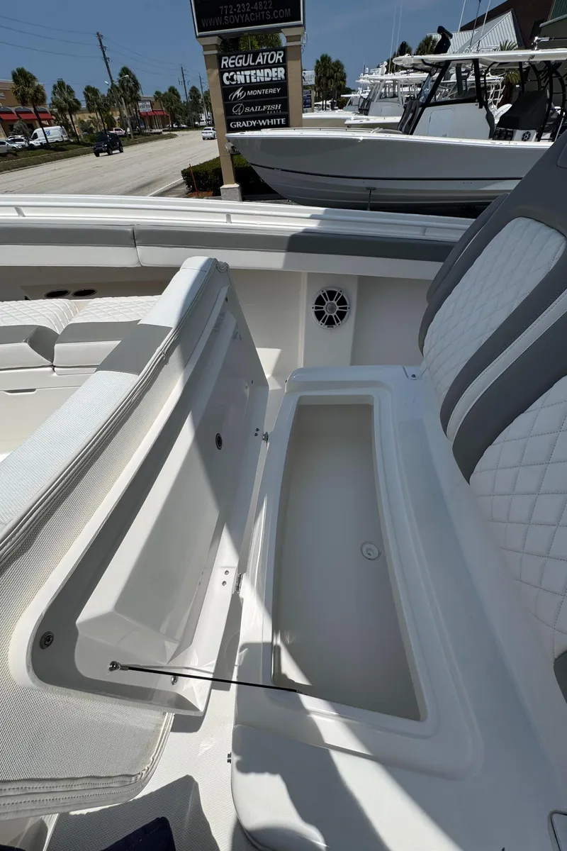 Slide: The Image of 2024 Regulator 31 boat interior with open storage compartment and seating. - 14