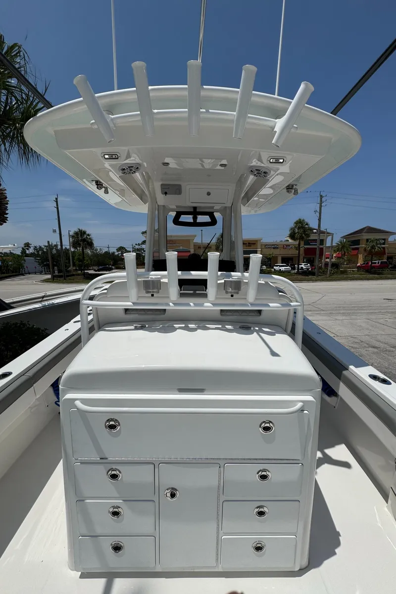 Slide: The Image of 2024 Regulator 31 boat with rod holders and storage drawers, viewed from the deck. - 4