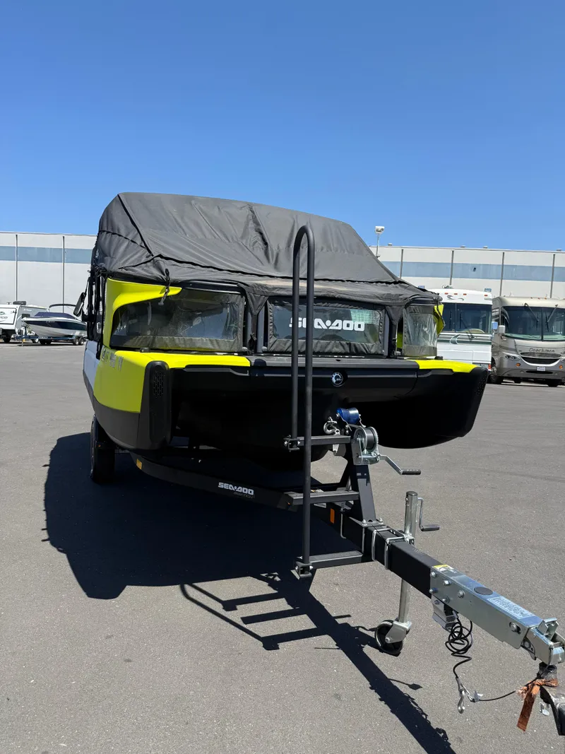 Slide: The Image of 2022 Sea-Doo Switch 18 boat with cover on trailer, parked outdoors. - 5