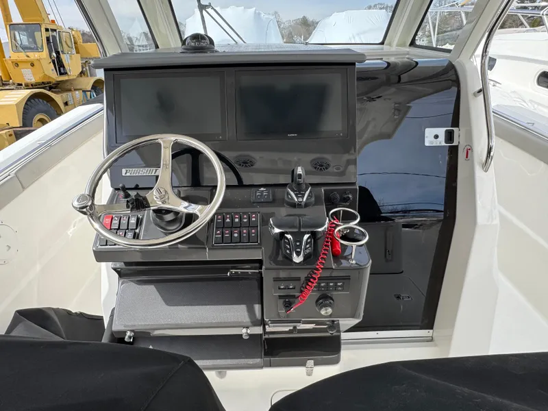 Slide: The Image of Helm of 2025 Pursuit S 328 boat with dual screens and steering wheel. - 10