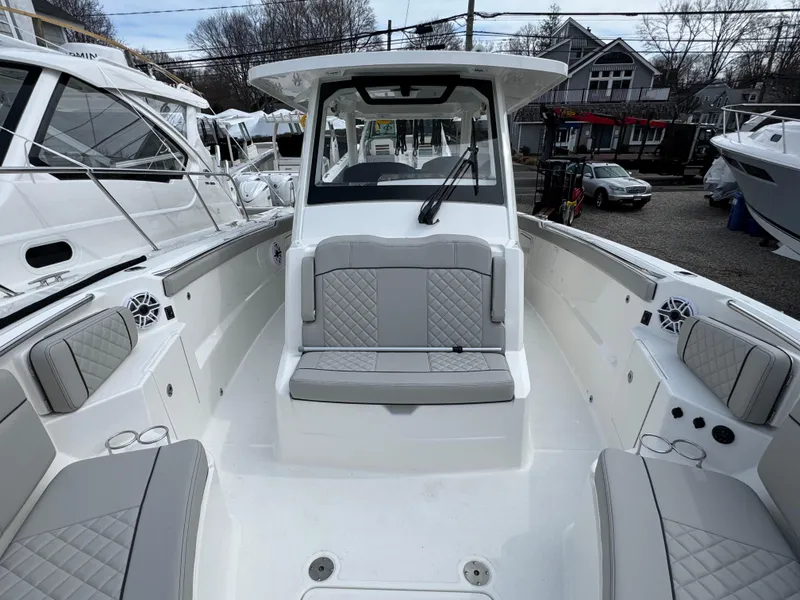 Slide: The Image of 2025 Pursuit S 328 boat interior with cushioned seating and modern design. - 14