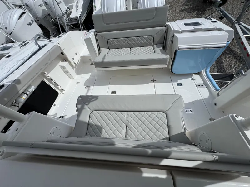 Slide: The Image of 2025 Pursuit S 328 boat interior with cushioned seating and storage compartments. - 3