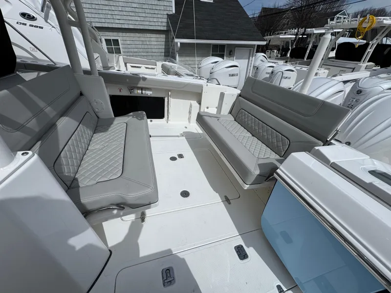 Slide: The Image of 2025 Pursuit S 328 boat interior with gray seating and modern design. - 4