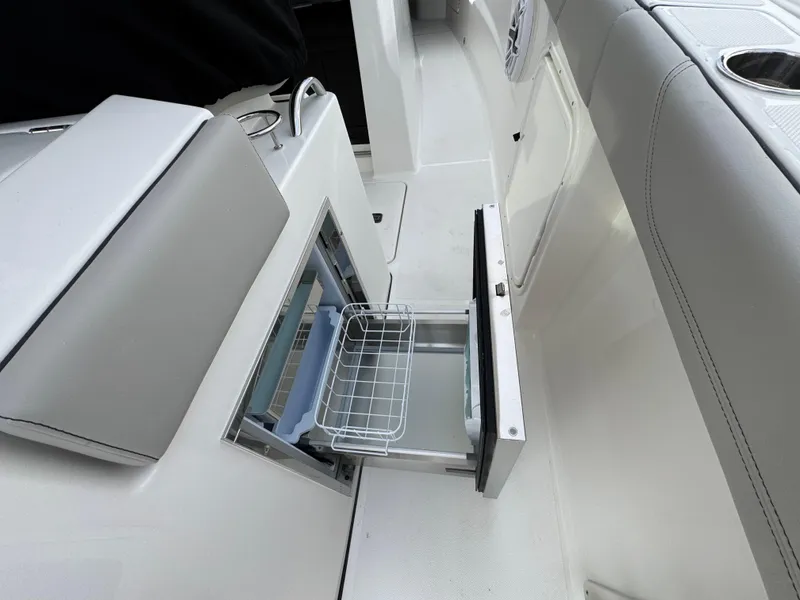 Slide: The Image of 2025 Pursuit S 328 boat interior with open storage compartment and seating. - 6