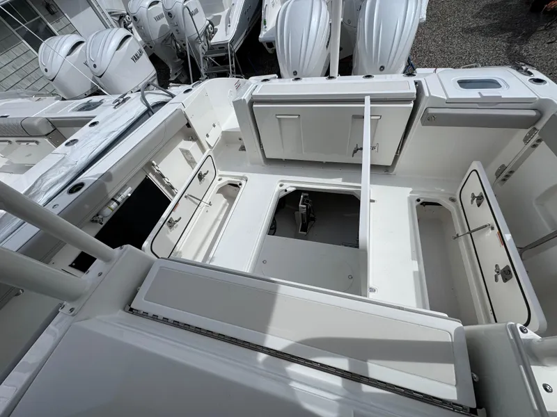 Slide: The Image of 2025 Pursuit S 328 boat interior with open storage compartments and sleek design. - 8