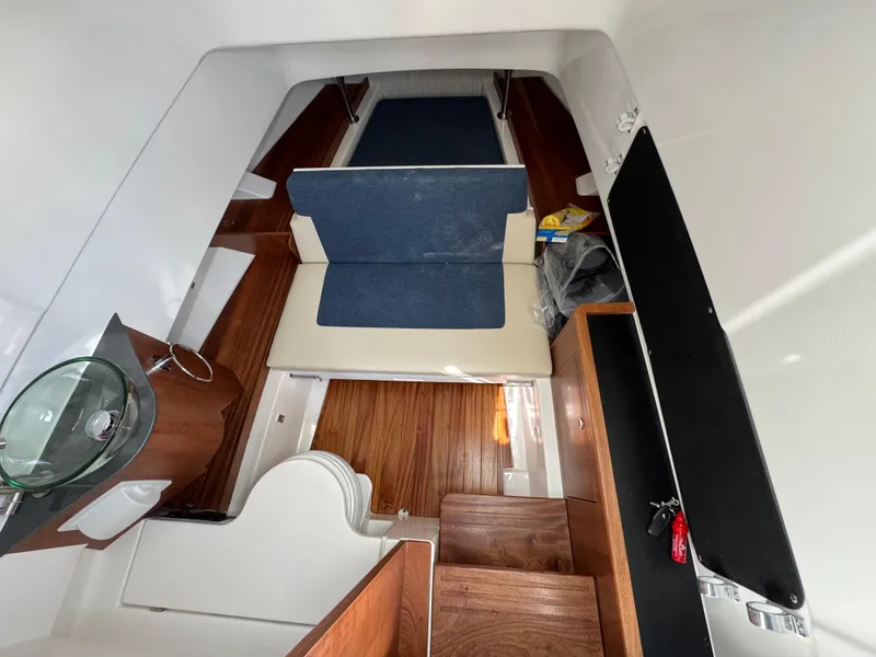 Slide: The Image of 2025 Pursuit S 328 cabin interior with wooden flooring and seating area. - 9