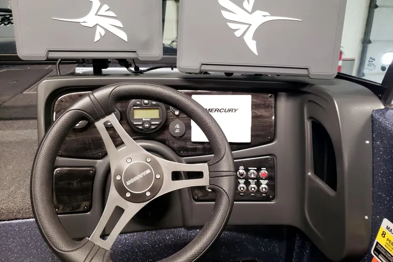 Slide: The Image of 2025 Warrior V238 boat in garage, on trailer, with Mercury engine. - 1