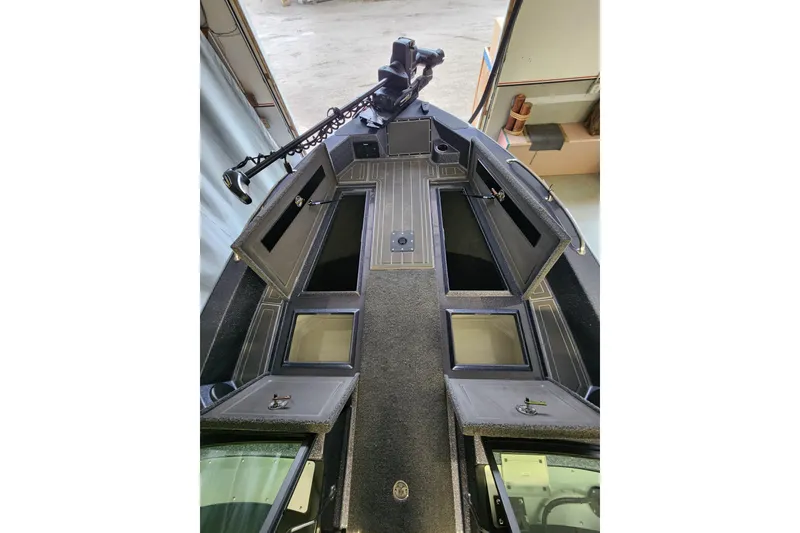 Slide: The Image of 2025 Warrior V238 boat interior with open storage compartments and fishing equipment. - 11