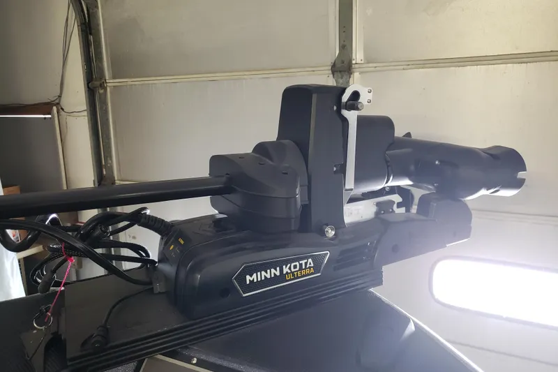 Slide: The Image of Minn Kota Ulterra motor on 2025 Warrior V238 boat in garage setting. - 16