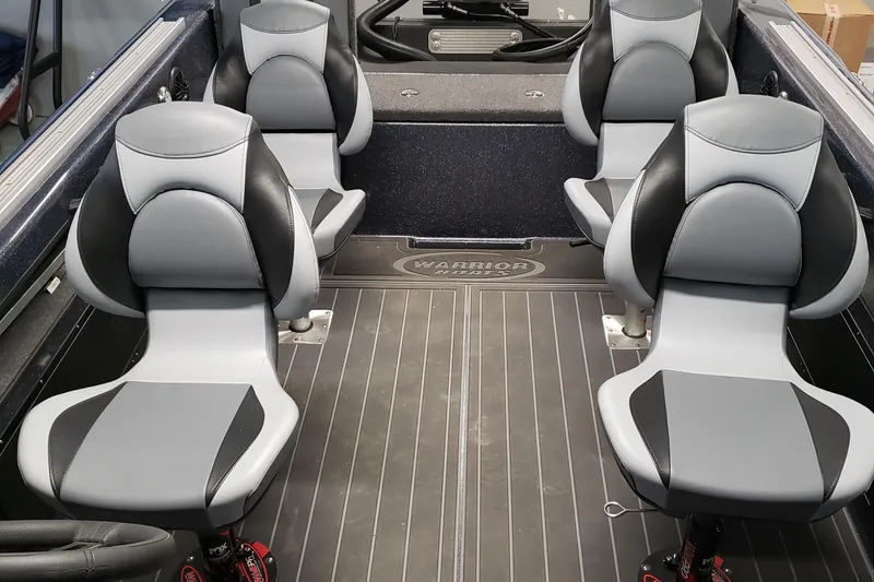 Slide: The Image of 2024 Warrior V238 boat with Mercury outboard motor in a garage setting. - 4