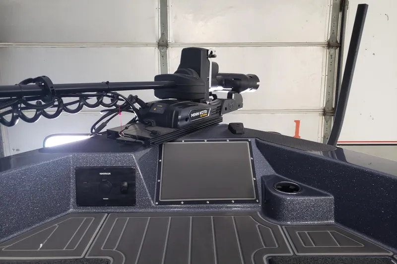 Slide: The Image of 2025 Warrior V238 boat interior with modern dashboard, steering wheel, and comfortable seating. - 6