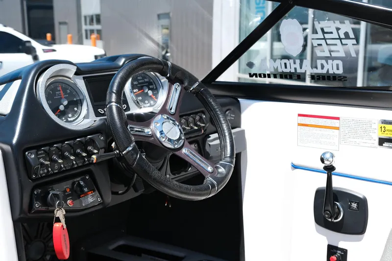 Slide: The Image of 2017 Moomba Mondo boat dashboard with steering wheel and control panel. - 16