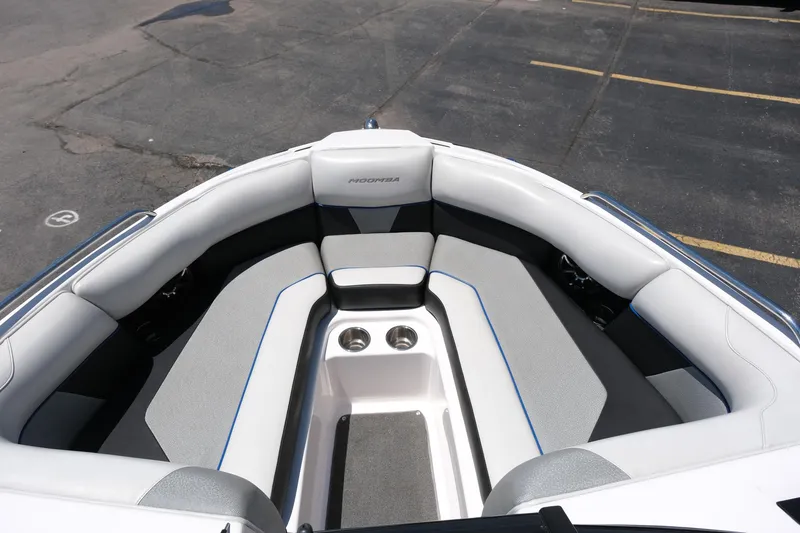 Slide: The Image of 2017 Moomba Mondo boat interior with gray and white seating, cup holders, and sleek design. - 19