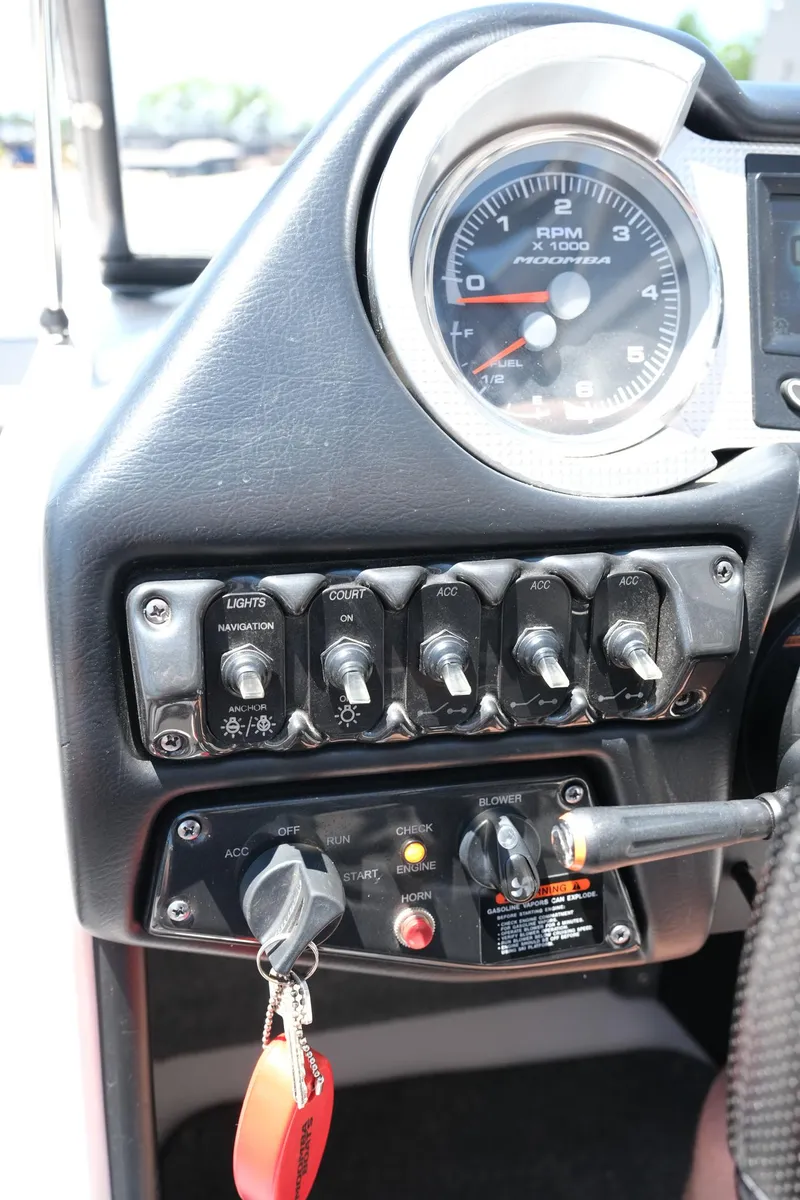 Slide: The Image of Dashboard controls of a 2017 Moomba Mondo boat with switches and gauges. - 26