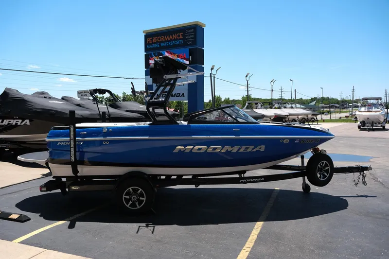 Slide: The Image of 2017 Moomba Mondo blue boat on trailer at dealership parking lot. - 6