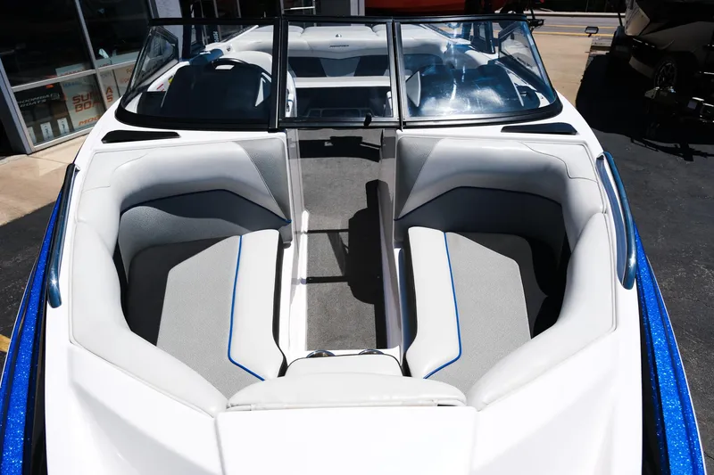 Slide: The Image of 2017 Moomba Mondo boat interior with white and gray seating, blue accents, and windshield. - 9