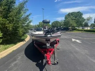Slide: The Image of 2000 Skeeter SX 176 boat on trailer in parking lot, sunny day. - 2