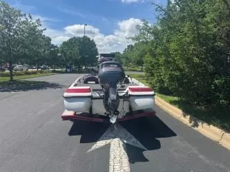 Slide: The Image of 2000 Skeeter SX 176 boat on road, rear view, sunny day, surrounded by trees. - 3